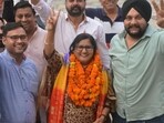 BJP candidate Paramjeet Kaur from ward 2 celebrates her victory with supporters at the party’s Panchkula office. (Sant Arora/HT)