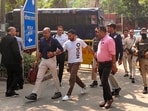 National Investigation Agency (NIA) officials bringing wanted narco-terrorist Iqbal Singh alias Shera, in white, to the Patiala House court, after his successful extradition from Portugal, in New Delhi on Wednesday. (PTI)