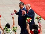 President Donald Trump and China's Xi Jinping greet crowds in beijing