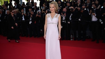 Gillian Anderson wore a champagne floral embroidered Miu Miu dress from the Spring/Summer 2022 collection, styled with loose long curls. (AFP) Gillian Anderson wore a champagne floral embroidered Miu Miu dress from the Spring/Summer 2022 collection, styled with loose long curls. (AFP)