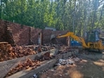 A joint anti-encroachment operation being conducted by district administration and the police against a drug peddler in Kulgam district on Thursday. (PTI)