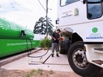 A municipal worker refuels a truck with BeVant biofuel, produced by Be8, as geopolitical tensions impact the global oil market.
