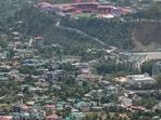 A general view of houses along with the Himachal Pradesh Cricket Association Stadium (top) as seen from Indru Nag near Dharamsala on May 15, 2026. A general view of houses along with the Himachal Pradesh Cricket Association Stadium (top) as seen from Indru Nag near Dharamsala on May 15, 2026.