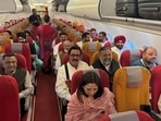 Passengers aboard the Air India Delhi-Ludhiana flight on Friday. Union minister Ravneet Singh Bittu, MPs Vikramjit Singh Sahney and Rajinder Gupta were among BJP leaders aboard the inaugural flight that landed at Halwara Civil Terminal in the morning. (HT Photo)