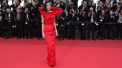 Demi Moore attended the Fatherland premiere at Cannes in a sculptural red Gucci gown, paired with dazzling Chopard diamonds. (AFP) Demi Moore attended the Fatherland premiere at Cannes in a sculptural red Gucci gown, paired with dazzling Chopard diamonds. (AFP)