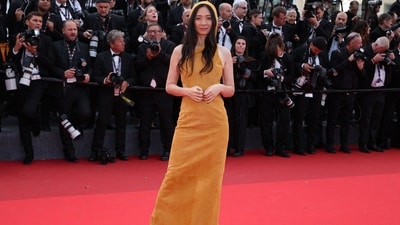 Chloé Zhao arrived at the Fatherland screening in a mustard-toned suede hooded gown featuring striking bodice cut-outs. (AFP) Chloé Zhao arrived at the Fatherland screening in a mustard-toned suede hooded gown featuring striking bodice cut-outs. (AFP)