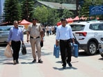 Election duty employees on the way to polling stations with EVMs for the urban local body polls in Mandi on Saturday. (Birbal Sharma/HT)