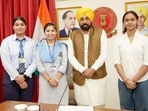 Punjab Chief Minister Bhagwant Singh Mann felicitates PSEB Class 12 toppers in Chandigarh on Thursday.