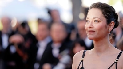 Marion Cotillard wore a black Chanel look for the occasion, styled perfectly with diamond stud earrings, minimal makeup, and a messy hairbun.&nbsp; (AP Photo/Millie Turner)