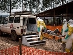 Health workers move a patient to a hospital after he was found to have Ebola. Health workers move a patient to a hospital after he was found to have Ebola.