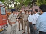 Police officials at the postmortem house. (HT )