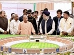 Uttar Pradesh chief minister Yogi Adityanath and Union minister for petroleum and natural gas Hardeep Singh Puri viewing the model of the proposed international cricket stadium, in Gorakhpur on Saturday. (PTI PHOTO)