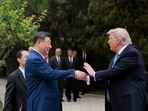 U.S. President Donald Trump speaks with Chinese President Xi Jinping while leaving after a visit to the Zhongnanhai Garden in Beijing