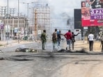anti-riot police patrol a barricaded road during protests over rising fuel prices in kenya (Photo by Tony KARUMBA / AFP) anti-riot police patrol a barricaded road during protests over rising fuel prices in kenya (Photo by Tony KARUMBA / AFP)