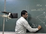 Sangli, India - June 17, 2021: Teachers teaching in online classes to students in front of a mobile camera mounted on a stand in empty classrooms on the 1st day after the reopening of schools for the academic year amid pandemic situation after the unlocking of lockdown restrictions in Sangli, India, on Thursday, June 17, 2021. (Photo by Uday Deolekar/HT Photo) (HT PHOTO) Sangli, India - June 17, 2021: Teachers teaching in online classes to students in front of a mobile camera mounted on a stand in empty classrooms on the 1st day after the reopening of schools for the academic year amid pandemic situation after the unlocking of lockdown restrictions in Sangli, India, on Thursday, June 17, 2021. (Photo by Uday Deolekar/HT Photo) (HT PHOTO)