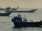 TOPSHOT - Vessels are seen anchored in the Strait of Hormuz, off the port city of Khasab on Oman's northern Musandam Peninsula on May 17, 2026. (Photo by AFP) / (AFP)
