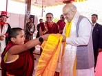 Union Home Minister Amit Shah interacts with a novice monk during the inauguration of the first international exposition of holy relics of Lord Buddha on the occassion of Buddh Purnima, in Ladakh. (PTI)