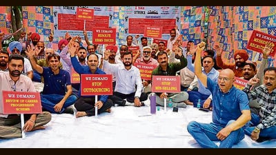 Employees stage protest at Fountain Chowk in Ludhiana on Monday. Decision on strike to follow a meeting on May 21. (Gurpreet Singh/HT)