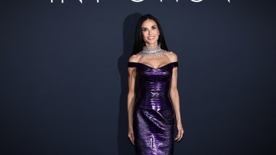 Demi Moore turned heads in a striking purple vinyl crocodile leather gown featuring an elegant off-shoulder neckline as she posed at the photocall for the 2026 Kering Women in Motion Awards during the Cannes Film Festival. Elevating the glamorous look further, her bold statement neckpiece emerged as the standout accessory of the evening. (REUTERS)