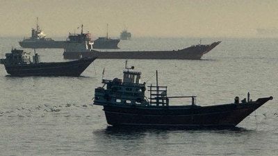 TOPSHOT - Vessels are seen anchored in the Strait of Hormuz, off the port city of Khasab on Oman's northern Musandam Peninsula on May 17, 2026. (Photo by AFP) / (AFP)
