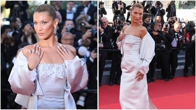 Bella Hadid stunned in an ice-blue satin gown with a structured square neckline adorned with delicate crystal embellishments. The fitted silhouette hugged the body elegantly before flowing into a clean, floor-length finish, while dramatic oversized off-shoulder sleeves with sculptural folds framed her arms. (AFP) Bella Hadid stunned in an ice-blue satin gown with a structured square neckline adorned with delicate crystal embellishments. The fitted silhouette hugged the body elegantly before flowing into a clean, floor-length finish, while dramatic oversized off-shoulder sleeves with sculptural folds framed her arms. (AFP)