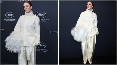 Julianne Moore posed for the Kering's Women in Motion Award photocall in an avant-garde monochormatic ivory ensemble. It featured an oversized structured shirt with a dramatic high collar and relaxed sleeves, paired with fluid satin trousers. The outfit was accessorised with a voluminous white feathered clutch tucked under the arm. (AFP) Julianne Moore posed for the Kering's Women in Motion Award photocall in an avant-garde monochormatic ivory ensemble. It featured an oversized structured shirt with a dramatic high collar and relaxed sleeves, paired with fluid satin trousers. The outfit was accessorised with a voluminous white feathered clutch tucked under the arm. (AFP)