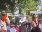 The video shows the rape accused – dressed in white with marigold garlands around his neck – being carried on someone's shoulders. The video shows the rape accused – dressed in white with marigold garlands around his neck – being carried on someone's shoulders.