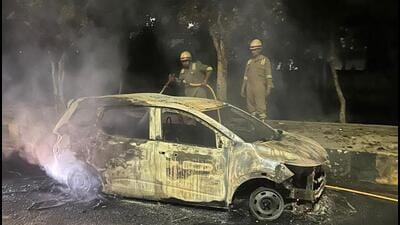 The incident is suspected to have been caused by engine overheating while two people were travelling in the car, said an official. (HT Photo) The incident is suspected to have been caused by engine overheating while two people were travelling in the car, said an official. (HT Photo)