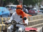 People seen covering their head and face with cloth to protect themselves from heat wave on a hot summer day. People seen covering their head and face with cloth to protect themselves from heat wave on a hot summer day.