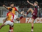 Mohun Bagan Super Giant's Jason Cummings, right, and others vie for the ball against East Bengal. (PTI)