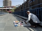 The bridge is totally deserted, except for vendor Vijay, manning his modest stall of ear pods. (HT Photo)
