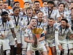 Aston Villa players celebrate with the Europa League trophy.