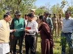 Forest minister Subodh Uniyal and department officials inspecting the site where two tigers were found dead in Shyampur forest range