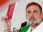 Lok Sabha Leader of Opposition Rahul Gandhi holds up a copy of the Constitution of India while addressing a Congress event, in Raebareli on Wednesday. (ANI)