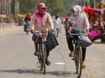 People cover their faces to protect themselves from the heatwave on a summer day, in Prayagraj, UP