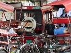 Rickshaw pullers rest amid intense summer heat in New Delhi on Wednesday. (ANI)