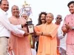 UP CM Yogi Adityanath presenting a trophy to a winner of 46th Junior National Rowing Championship in Gorakhpur on May 21. (HT photo)