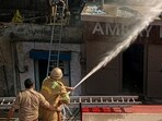 We had to break certain walls inside to gain access to control the fire at the unit. With timely intervention, other units nearby were saved in time. People at the spot told us that the fire possibly started due to a short-circuit. But no loss of life or injury was reported,” the CFO said. (Sakib Ali/HT Photo)