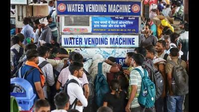 Passengers throng a water vending machine on a hot summer day, at Lucknow Charbagh railway station, on Thursday. (ANI Photo)