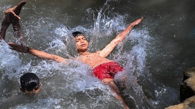 Children cool off in a small pond near the Yamuna river in New Delhi on Wednesday. (Vipin Kumar/ HT Photo)