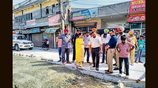 Civic body officials inspecting an under-construction road in Giaspura, Ludhiana, on Thursday. (HT Photo)