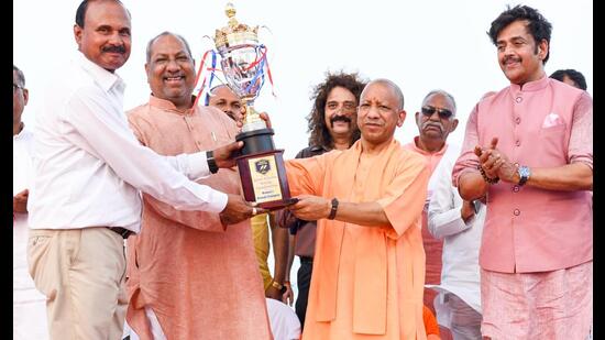 UP CM Yogi Adityanath presenting a trophy to a winner of 46th Junior National Rowing Championship in Gorakhpur on May 21. (HT photo)