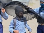 Student seen covering head and face with cloth to protect from heat wave on a hot summer day at sector-11 near Mini Secretariat, in Gurugram, India, on Thursday, 21 May 2026. 