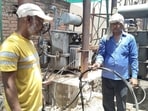 Electricity department staff changing damaged cables in Prayagraj on Friday. (HT)