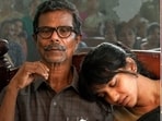 Indrans, Anagha and Suriya in stills from RJ Balaji's Karuppu. 