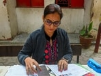 Noida, India - December 01, 2025: Voters fill out their Special Intensive Revision (SIR) forms at a BLO camp set up at Government Adarsh Primary School in Sector 12, in Noida, India, on Monday ,December 01, 2025. (Photo by Sunil Ghosh / Hindustan Times)