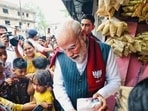 Prime Minister Narendra Modi offers Jhalmuri snack to a local, in Jhargram on Sunday. (@narendramodi)