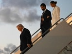 US President Donald Trump, followed by Donald Trump Jr. and Bettina Anderson step off Air Force One upon arrival at Palm Beach International Airport in West Palm Beach, Florida.