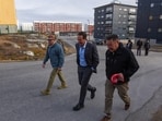 Louisiana Gov. Jeff Landry, wearing a blue shirt, walks through Nuuk, Greenland.