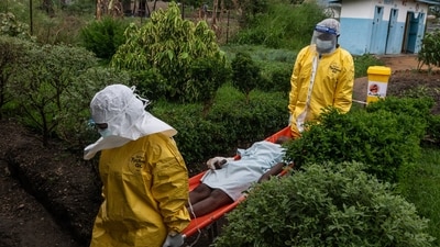 Medical staff carry an Ebola patient to a treatment center in Rwampara, Congo, Thursday, May 21, 2026. (AP Photo/Moses Sawasawa)